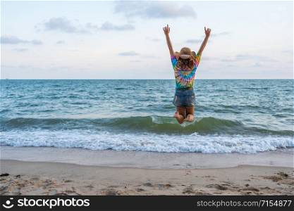woman enjoy and jumping on the sea beach