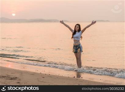 woman enjoy on sea beach with sunset. woman enjoy on the sea beach with sunset