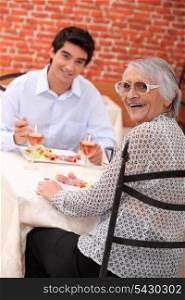 Woman enjoying a meal out with her grandson