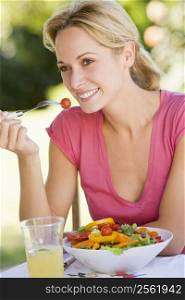 Woman Enjoying A Salad In A Garden