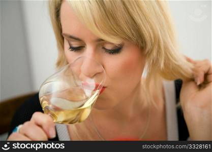 Woman enjoying a zip of white wine