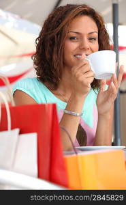 Woman enjoying coffee during shopping trip