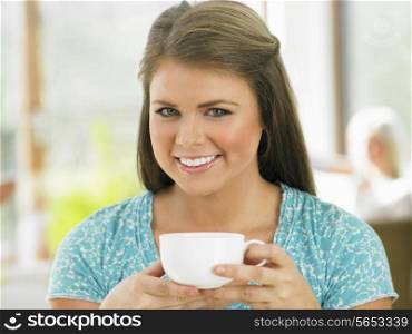 Woman Enjoying Drink In Cafe