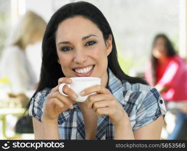 Woman Enjoying Drink In Cafe