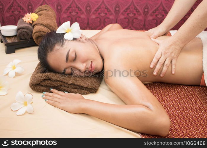 Woman enjoying during a back massage at a spa.