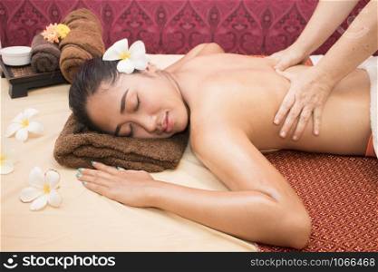 Woman enjoying during a back massage at a spa.