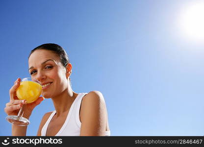 Woman enjoying fruit juice outdoors