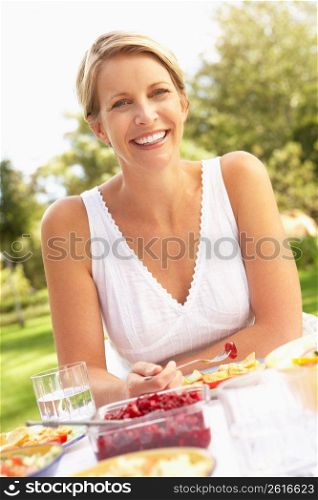 Woman Enjoying Meal In Garden