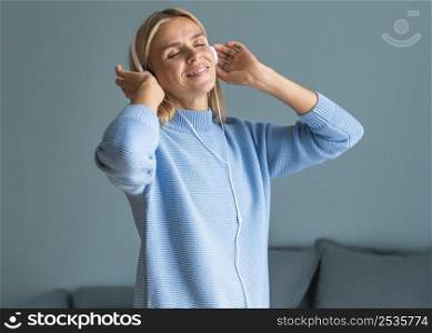 woman enjoying music her headphones home during pandemic