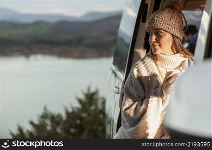 woman enjoying nature view from car while road trip
