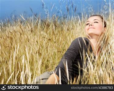 Woman enjoying on the wheat field, nature at autumn, natural landscape background, female outdoor