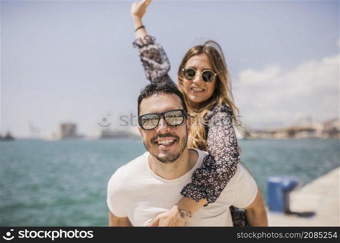 woman enjoying piggyback ride his boyfriend s back