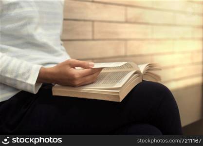 Woman enjoying reading a book. Education and reading concept