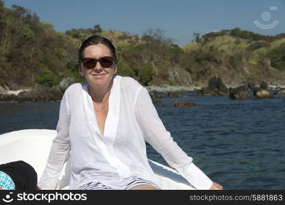 Woman enjoying relaxing on a boat, Zihuatanejo, Guerrero, Mexico