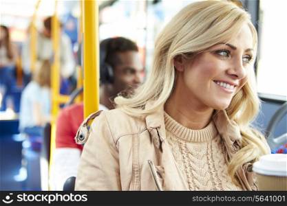 Woman Enjoying Takeaway Drink On Bus Journey