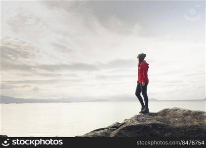 Woman enjoying the morning view of the coast