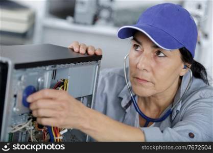 woman examined her computer with a stethoscope