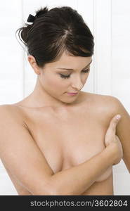 Woman examining breast