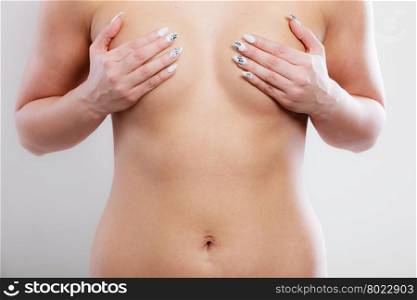Woman examining her breasts. Health care medical concept. Close up young woman examining her breasts for lumps or signs of breast cancer