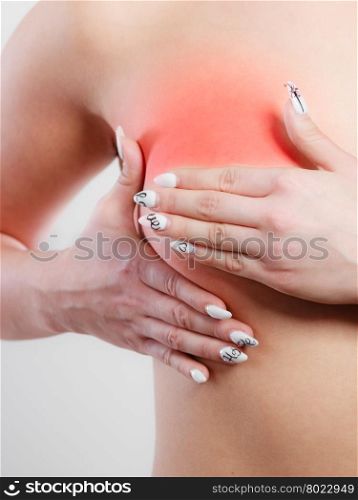 Woman examining her breasts. Health care medical concept. Close up young woman examining her breasts for lumps or signs of breast cancer
