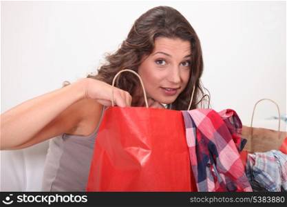 Woman examining shopping bags