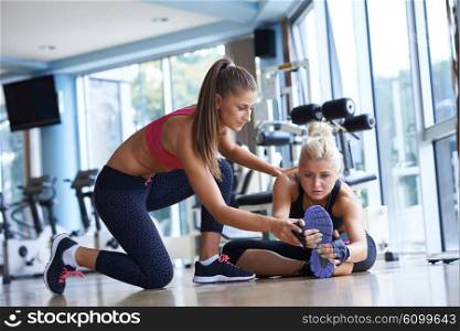 woman exercise and working out with fitness personal trainer in gym