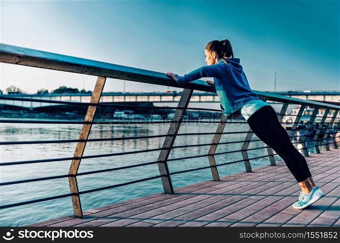 Woman exercising by the river