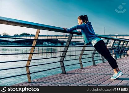 Woman exercising by the river