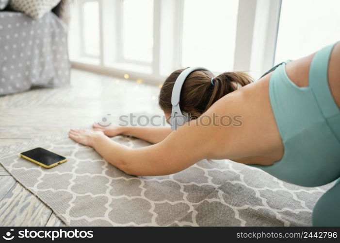 woman exercising mat listening music 5