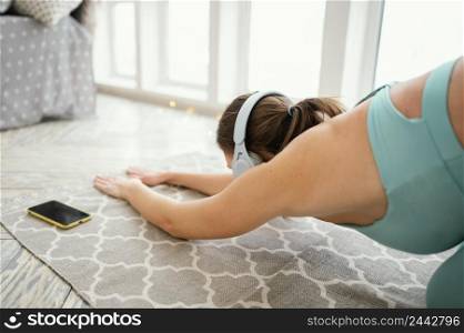 woman exercising mat listening music 5