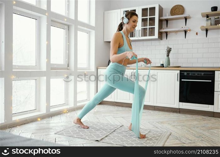 woman exercising mat with elastic band