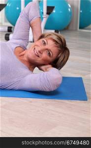Woman exercising on a gym mat