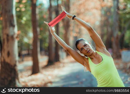 Woman Exercising with Resistance Band Outdoors