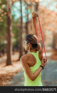 Woman Exercising with Resistance Band Outdoors