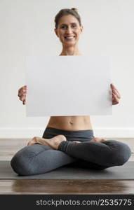 woman exercising yoga holding blank placard