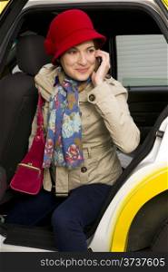 Woman exits a Taxi While Talking on Cellular Phone