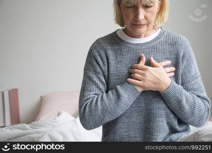 woman experiencing discomfort in his chest.Heart attack with woman clutching his chest.Severe heartache.woman suffering from chest pain.