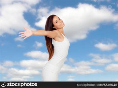 Woman expressing her freedom over a blue sky with clouds