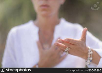 Woman expressing honesty with hands. Giving and receiving energy concept.. Honesty Hand Gesture