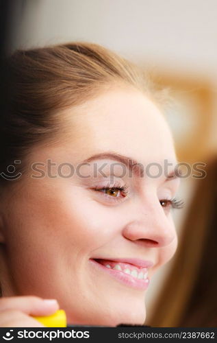 Woman face eyes painting. Girl applying black eye mascara to her eyelashes looking in bathroom mirror. Makeup female beauty. Woman applying black eye mascara to her eyelashes