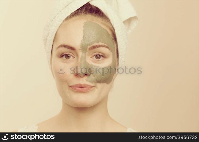 Woman face with green clay mud mask . Skin care. Woman face with green clay mud mask. Girl taking care of oily complexion. Beauty treatment.