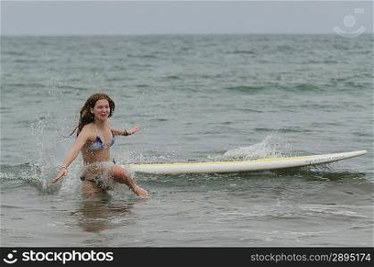 Woman fallen from a surfboard in the sea, Sayulita, Nayarit, Mexico