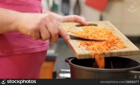 woman falls asleep cut carrots in pan.