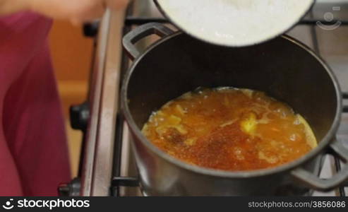 woman falls asleep rice in pan.