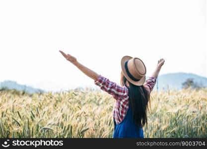 Woman farmer with barley field harvesting season