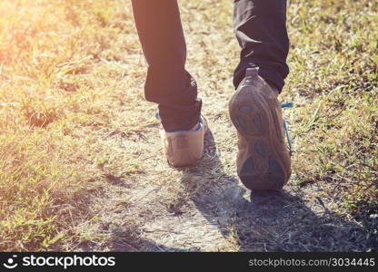 Woman feet walking in the forest