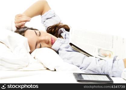 woman felt asleep under a newspaper with ebook reader aside. woman felt asleep under a newspaper with ebook reader aside on white background