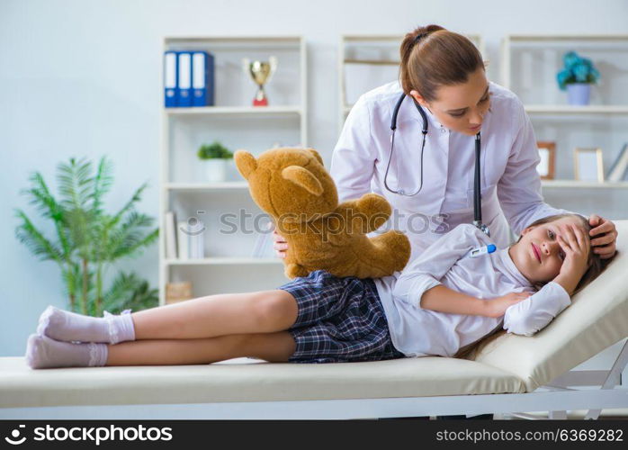 Woman female doctor examining little cute girl with toy bear