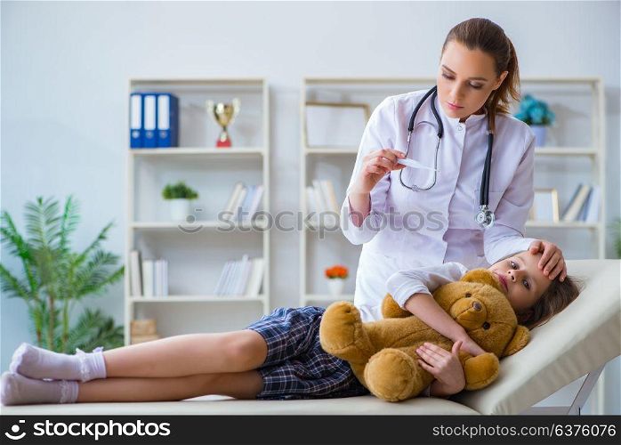 Woman female doctor examining little cute girl with toy bear