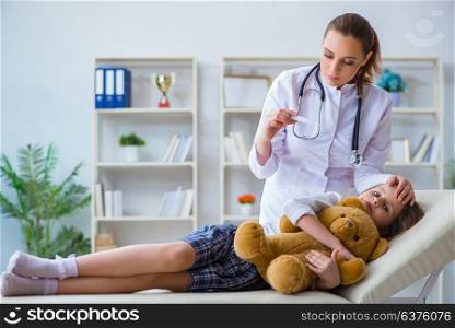 Woman female doctor examining little cute girl with toy bear